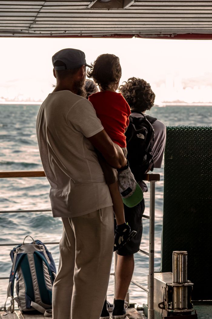 A family enjoys a scenic ferry ride across the Bosphorus in Istanbul, Turkey.